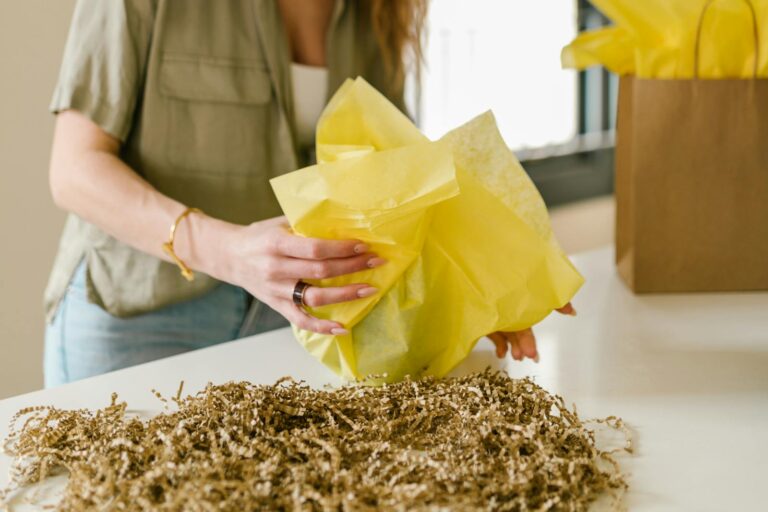 A Woman Wrapping a Gift Beside Shredded Papers